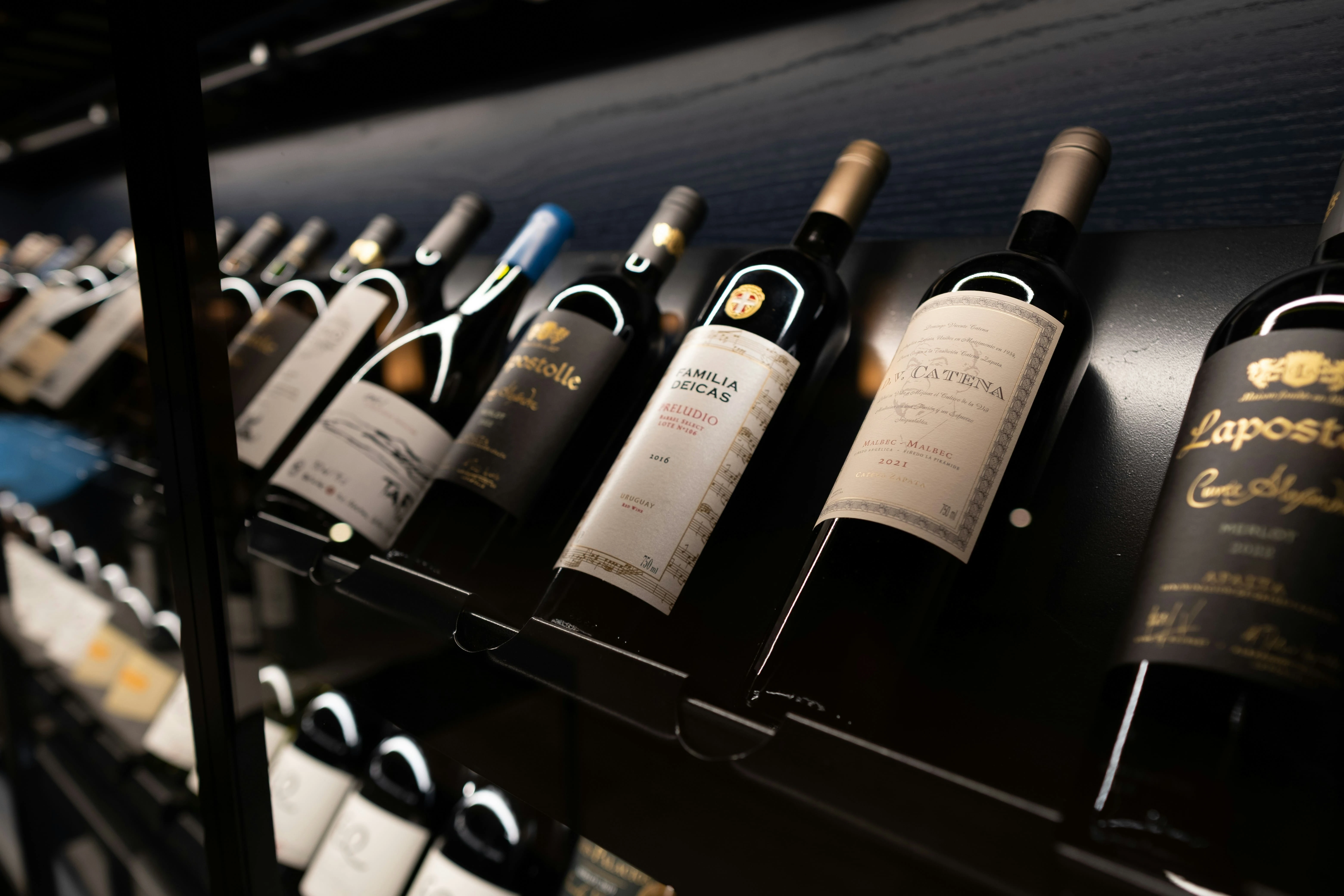 Une collection de bouteilles de vin sur une étagère.